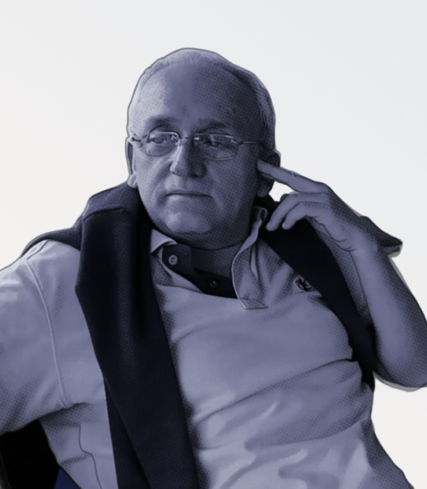 Stylized blue duotone portrait of a person facing the camera with arms crossed